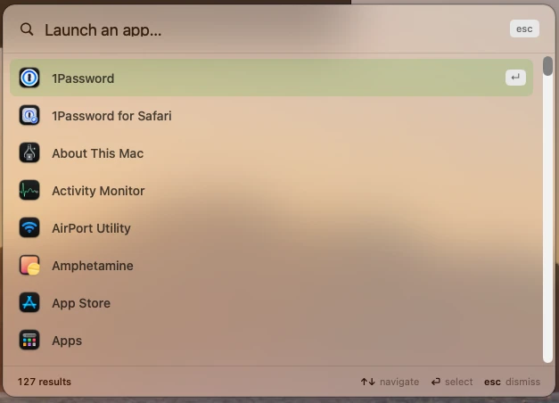 A chooser titled "Launch an app…" listing 1Password, Activity Monitor, App Store and other apps with their icons. 1Password is highlighted and the footer reads 127 results.